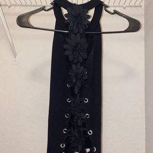 Black top with flowers in the back. [Size M]